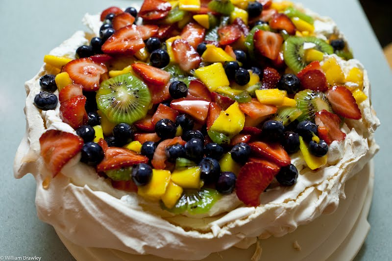 Pavlova - Baked meringue with whipped cream and sliced fresh fruit. The family did Christmas dinner different this year. Instead of the traditional turkey, stuffing, etc, each person picked a continent & a type of dish. We then got to pick a country from that continent and try to find a traditional food from each country (if possible, trying to find a Christmas dish from each country). So this year we had Asian spare ribs, German-style red cabbage with apples, Moroccan bread, sorrel (a Jamaican/Latin American hibiscus tea drink) and an Australian/New Zealand pavlova dessert. AMAZING. ? Photo by William Brawley, CC BY 2.0, via Wikimedia Commons