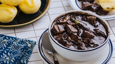 Dinuguan served with Puto (Filipino rice cake) for lunch. ? Photo by Kat, CC BY-SA 4.0, via Wikimedia Commons