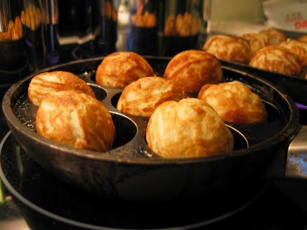 Æbleskiver is a traditional Danish dessert. If served in December, it is often accompanied by Gløgg. ? Photo by JoachimK, Public domain, via Wikimedia Commons