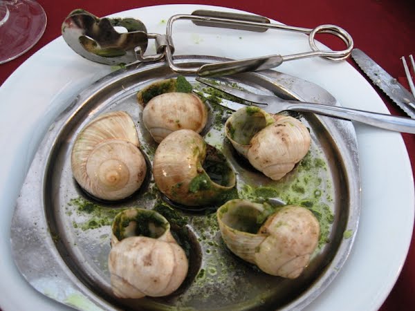 Plate of escargot with tongs and fork, taken in Bordeaux FRANCE ? Photo by Kadooshka, CC BY 3.0, via Wikimedia Commons