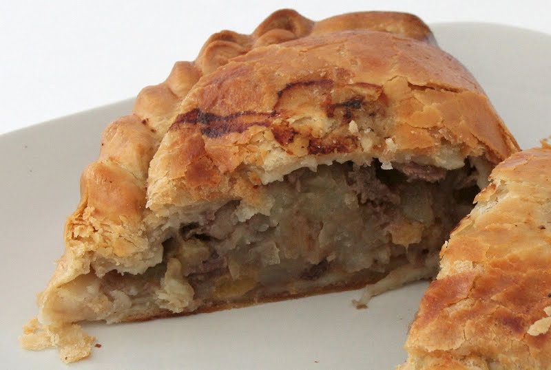 A Cornish pasty made by Warrens cut in half. The filling is beef steak, potato, turnip and onion. ? Photo by David Johnson [1], CC BY-SA 3.0, via Wikimedia Commons