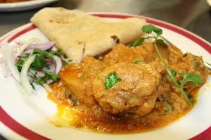 Indian Curry Chicken and roti dish ? Photo by Chowtimes.com, Attribution, via Wikimedia Commons