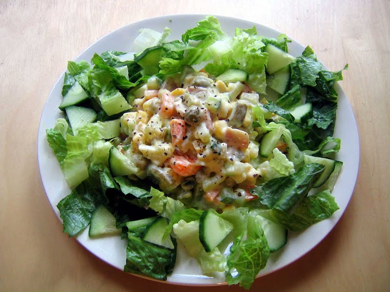 A home-made variant of the Russian Salad containing carrots, ham, onions, pickled gherkins, eggs, sweetcorn, cucumber, peas, potato and mayonnaise. ? Photo by Buzzcut50 at English Wikipedia, Public domain, via Wikimedia Commons
