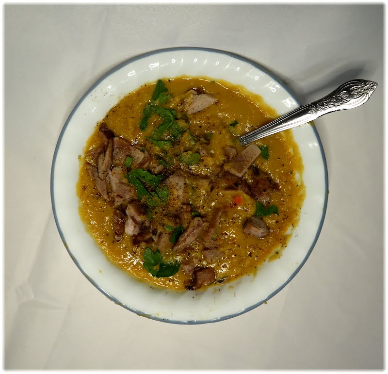 A bowl of Quebecois-style pea soup. The soup base is purred yellow split-peas and garden vegetables. Shredded ham-hock is mixed in. The soup is garnished with parsley and black pepper. ? Photo by Cnrowley, CC BY-SA 4.0, via Wikimedia Commons