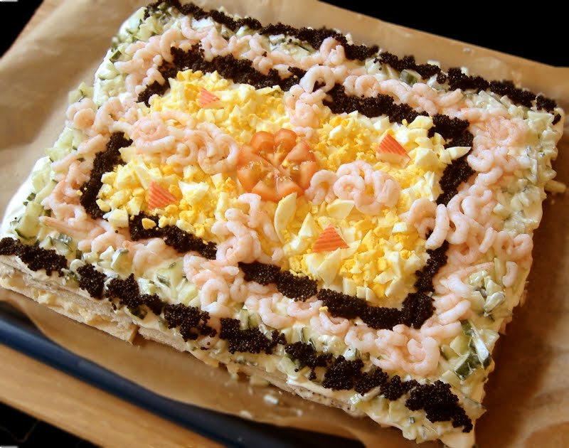 Smörgåstårta ("sandwich cake") garnished with prawns, egg, caviar and cucumber. ? Photo by Mereman at English Wikipedia, CC BY-SA 3.0, via Wikimedia Commons
