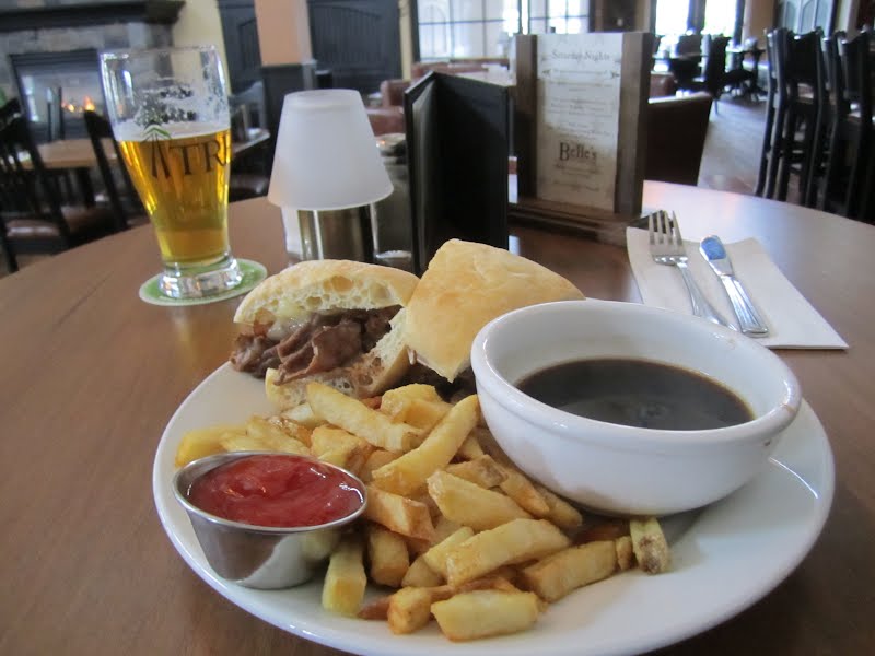 Roast beef dip, french fries, au jus, ketchup, beer and fire in background ? Photo by Vranak, CC BY-SA 3.0, via Wikimedia Commons