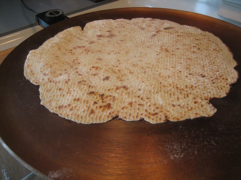A lefse on a griddle, cooking. ? Photo by Lance Fisher, CC BY-SA 2.0, via Wikimedia Commons