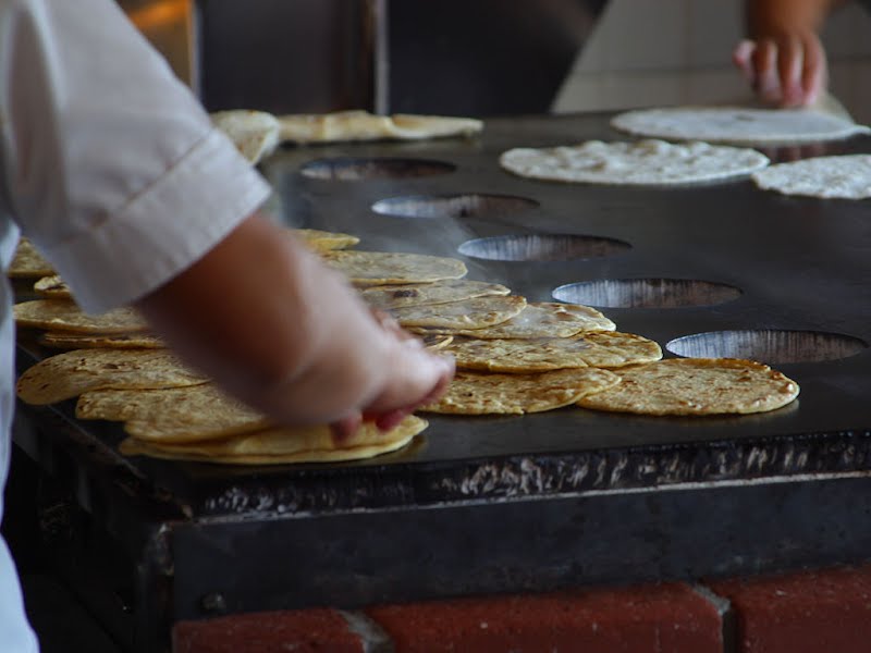 Tortillas being made in Old Town San Diego. ? Photo by Jon Sullivan, Public domain, via Wikimedia Commons
