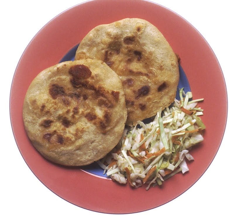 two pupusas on a plate served with a side of coleslaw-like salad ? Photo by Renee Comet (photographer), Public domain, via Wikimedia Commons