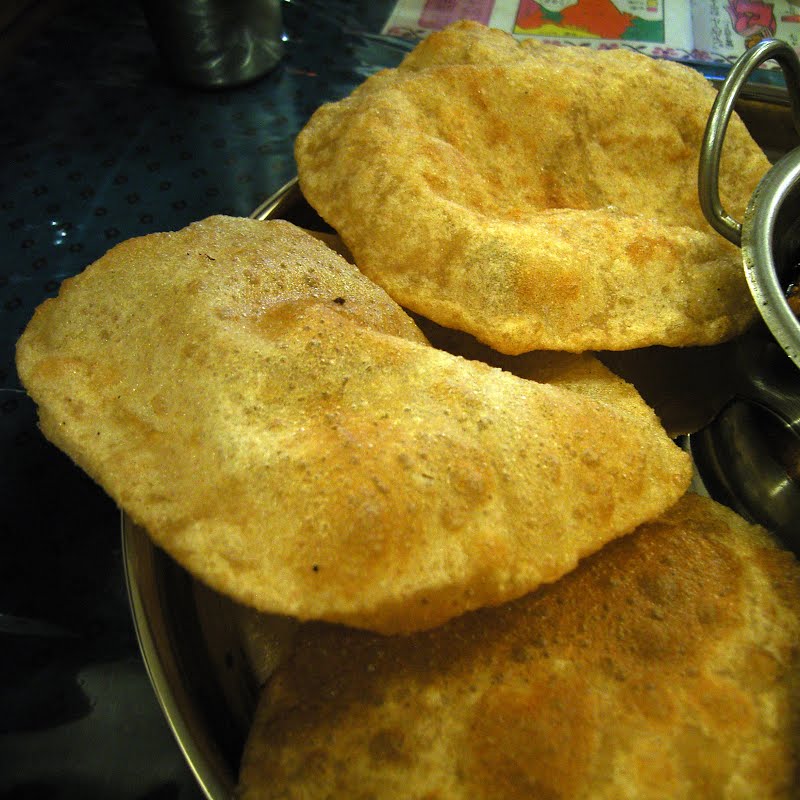 Puri de:Puri (Brot), ta:???? (????) A puri or poori is an Indian unleavened bread made from a dough of atta (whole grain durum wheat flour), water and salt by rolling it out into discs of approximately 12 cm diameter and deep frying it in ghee or vegetable oil. http://opencage.info/pics/large_6639.asp Location Indian restaurant "TIFFIN" Shin-Nagata, KOBE, Japan ???????????????? "TIFFIN" Copyright OpenCage ? Photo by Daiju Azuma, CC BY-SA 2.5, via Wikimedia Commons