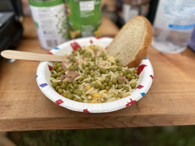 bowl of chicken orzo with a slice of bread