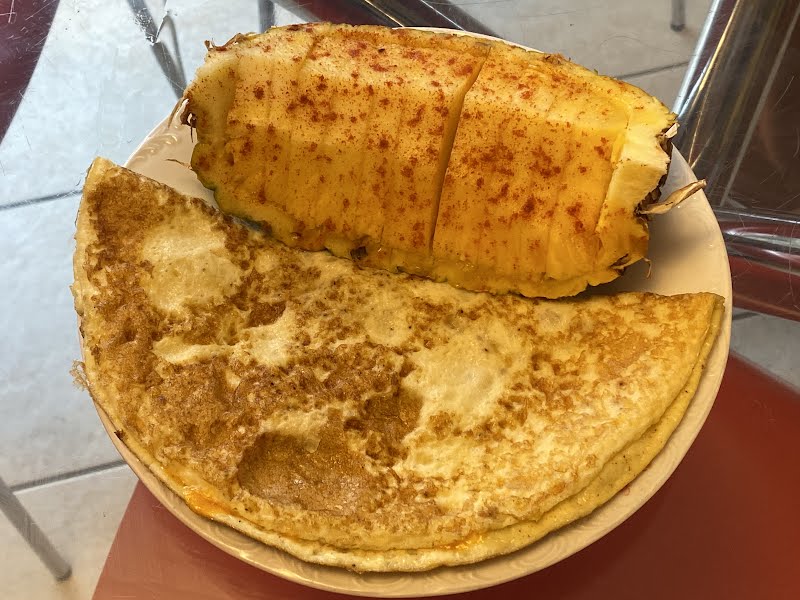 Just enough breakfast: omelet and quarter pineapple