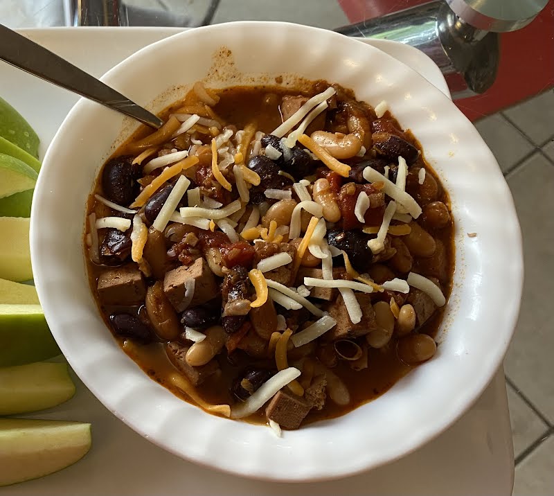 bowl of Tofu Chili with some grated cheese sprinkled over
