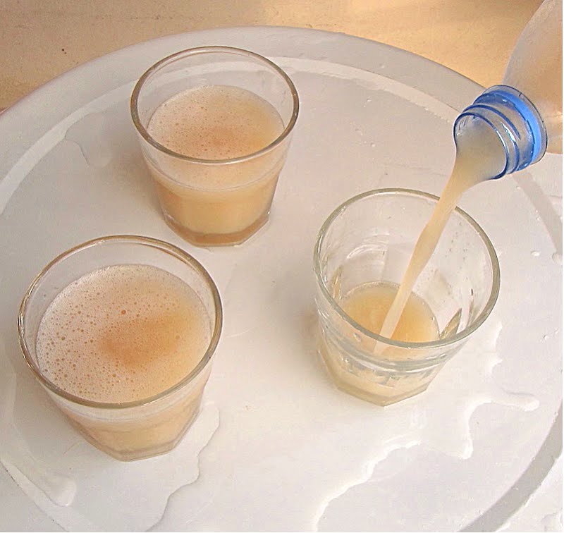 Fresh juice of the Adansonia digitata baobab. A pale slightly pinkish opaque juice made from dissolving the dry baobab fruit pulp in clean water and sieving out the seed and fibers. High in vitamin C, very tart, usually a sweetener like sugar is added. Shown freshly made and served from a re-used plastic bottle, as is commonly done. Hygiene is important in providing clean potable water for the dissolving and clean hands in the traditional hand-working to facilitate the dissolving of the pulp off the seeds. Factory-produced baobab juice (called 'bouye' in Wolof in Senegal, names vary between languages and countries) is becoming available for sale in urban supermarkets, but most families still find it easy and cheaper to make their own. ? Photo by T.K. Naliaka, CC BY-SA 4.0, via Wikimedia Commons