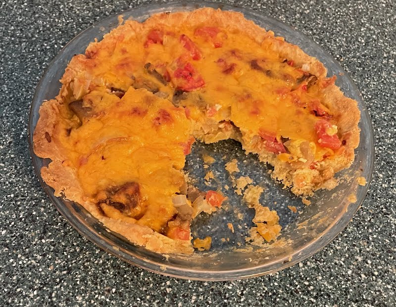 An onion and aubergine pie containing diced yellow onion, diced plum tomato, cheddar cheese, egg and milk. ? Photo by Deadbilly68, Public domain, via Wikimedia Commons