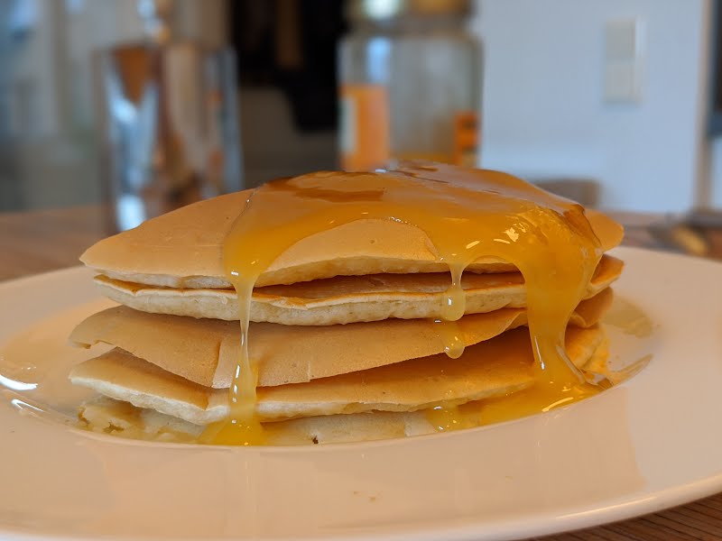 Pancake stack with honey ? Photo by Shisma, CC BY 4.0, via Wikimedia Commons