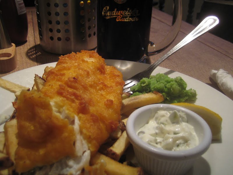Beer battered cod and Maris Piper chips, with mushy peas, tartare sauce and Budvar Dark Lager. ? Photo by Gordon Joly, CC BY-SA 3.0, via Wikimedia Commons